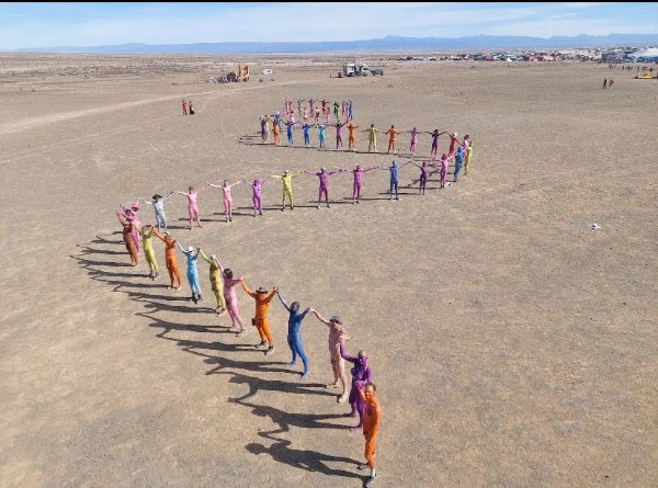 Beloved Burners! We are recruiting for the Naked Spectrum Art-Walk 2026! As a celebration of our human form, we paint ourselves into a naked colourful parade that will take place on the Friday of the burn at 12 noon at Birthday Suits*. This year, we are limiting numbers to around 100, and participants will be able to have a shower again after the walk to wash the paint off.

If you are keen to join us for the first time, or would like to participate once again this year, please click 'AfrikaBurn News' is in the 'Link in Bio' and apply.

Photo: Supplied